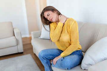 Obraz premium Woman suffering from backache at home. Lower Back Pain . Woman feels back pain massaging aching muscles, sad woman suffers from low-back