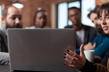 Diverse team analyzing marketing statistics using laptop working at business collaboration during business meeting in startup office. Multiethnic businesspeople brainstorming ideas for company project