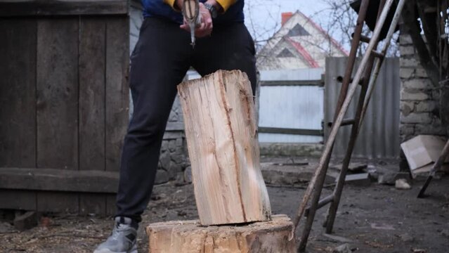 Cuts a wooden beam in half with an old ax