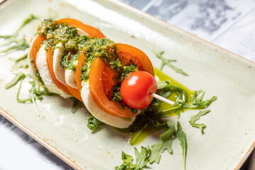 Caprese skewers with pesto sauce, top view