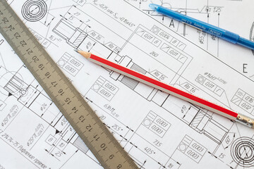 Pen, pencil and ruler lying on the drawing lying on the table of the design service