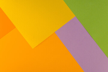 Bright abstract geometric paper background. Green, violet, yellow and orange trendy colors. The...