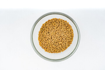 Fenugreek seeds - Methi dana closeup over isolated white