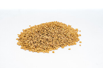 Fenugreek seeds , Methi dana closeup over isolated white