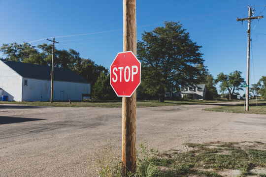 Stop sign at a road intersection. 