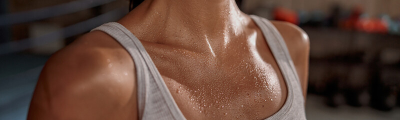Close up of shoulders and neck fit female with sweat on skin after workout - obrazy, fototapety, plakaty