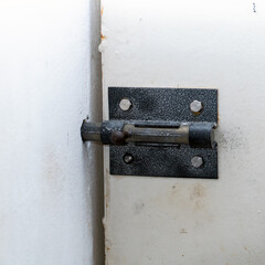 Steel latch on the white entrance door