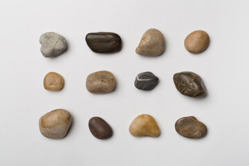Fototapeta na wymiar Set of sea stones on wooden background, top view