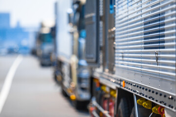 Urban Delivery Convoy Background / Detail view to blurred row of trucks at roadside (copy space) - 495873383