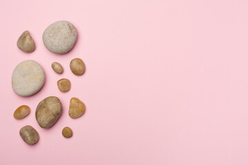 Set of sea stones on color background, top view