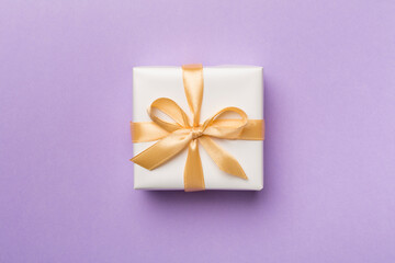 White gift box on color background, top view