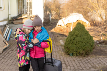 two little girls with the flag of ukraine, suitcase, dogs. Ukraine war migration. Collection of things in a suitcase. Flag of Ukraine, help. Krizin, military conflict.