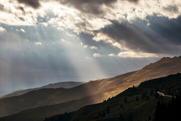 sunset over the mountains with sunrays