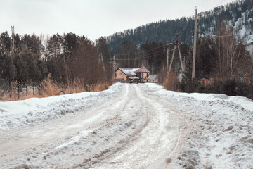 March in the village of Mansky, the snow began to melt, wooden cottages