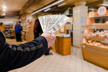 Closeup photo of man holding dollars, cash transactions , money concept of opportunities, benefits, obligations, taxes