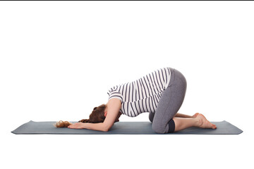Pregnancy yoga exercise - pregnant woman doing asana Balasana - child s pose isolated on white...