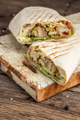 Kebab, pita, gyros, shaurma, wrap sandwich stuffed with sausages from minced meat, french fries, fresh vegetables, sauce. Street food. Takeaway food. vertical image. top view. place for text