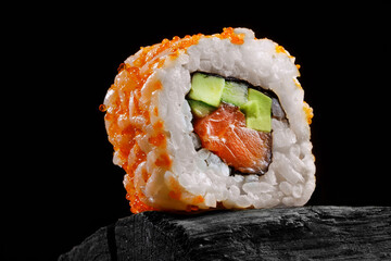 sushi roll with fish and rice on black wooden table background © st.kolesnikov