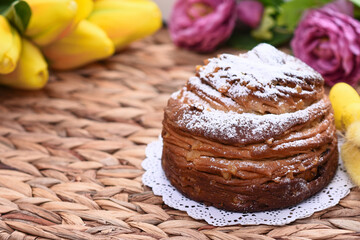 happy Easter! Stylish Easter bread and painted eggs on a wicker tray. Easter cake and eggs