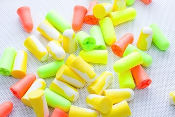 Pile of earplugs against noise in different colors isolated on white background.Protective...