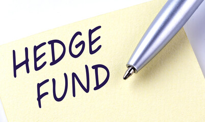 Sticky Note Message HEDGE FUND with pen on the white background