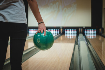 Bowling girl prepares for her throw on a specially modified bowling alley. Spending free time. A...