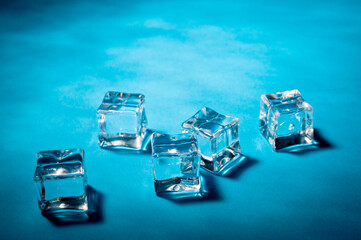 Clear ice cubes for cooling drinks on a blue background.