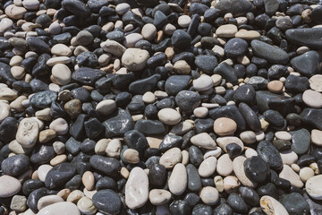 Texture of gray and white beach stones and pebbles 