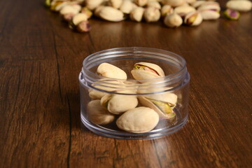 Fresh almonds in the wooden bowl, Organic almonds, almonds border white background, Almond nuts on a dark wooden background. Healthy snacks. Top view. Free space for text.