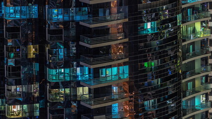 Night view of glowing windows in apartment tower timelapse.