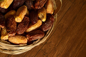Fresh almonds in the wooden bowl, Organic almonds, almonds border white background, Almond nuts on a dark wooden background. Healthy snacks. Top view. Free space for text.