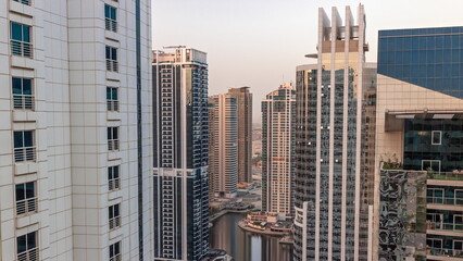 Fototapeta na wymiar Tall residential buildings at JLT aerial timelapse, part of the Dubai multi commodities centre mixed-use district.