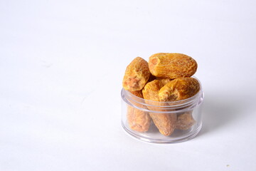 Fresh almonds in the wooden bowl, Organic almonds, almonds border white background, Almond nuts on a dark wooden background. Healthy snacks. Top view. Free space for text.