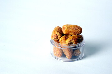 Fresh almonds in the wooden bowl, Organic almonds, almonds border white background, Almond nuts on a dark wooden background. Healthy snacks. Top view. Free space for text.