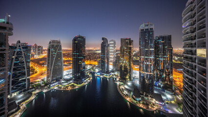 Tall residential buildings at JLT aerial night to day timelapse, part of the Dubai multi...