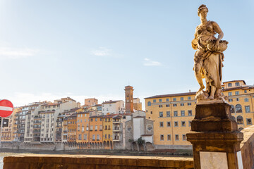 Riverside with old buildings and sculpture of Holy Trinity bridge in Florence. Travel italian cities of Tuscany. Italian Renaissance architecture