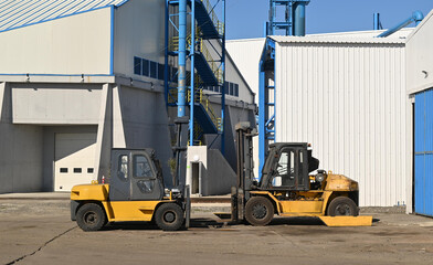 two forklift in warehouse. Warehousing, machinery concept. Logistics in stock.