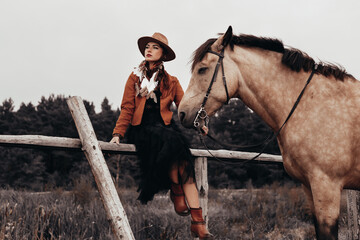 Bohemian, boho, gypsy, hippie style lady. Walk in nature in the forest with a horse, romantic mood of summer