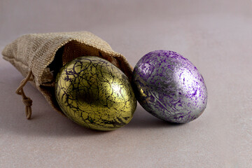 Colored easter eggs in a sack on light background