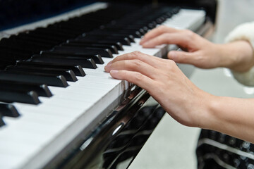Obraz premium Close up of woman hands playing piano