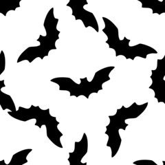 black bat silhouette pattern for Halloween. A seamless pattern of a soaring bat with pointed ears is drawn in the style of doodles randomly placed on white for textiles