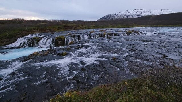 Picturesque autumn waterfall Bruarfoss late evening dusk view. Season changing in southern Highlands of Iceland.
