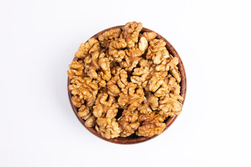 Top view of Walnuts in a wooden bowl  white background