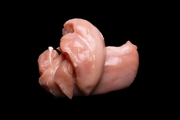 Raw chicken fillet isolated on a black background.