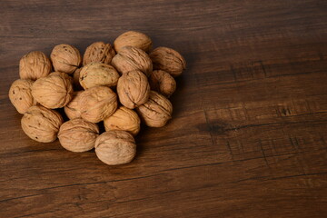 Fresh almonds in the wooden bowl, Organic almonds, almonds border white background, Almond nuts on a dark wooden background. Healthy snacks. Top view. Free space for text.
