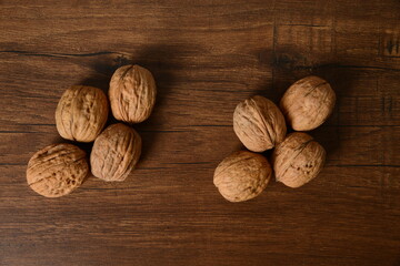 Fresh almonds in the wooden bowl, Organic almonds, almonds border white background, Almond nuts on a dark wooden background. Healthy snacks. Top view. Free space for text.