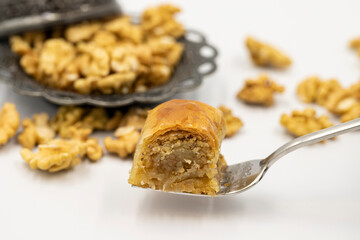 Walnut baklava on a white background. Traditional Turkish cuisine delicacies. Local name is cevizli sarma baklava