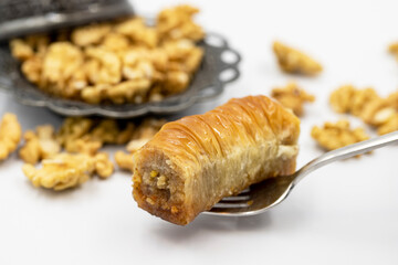 Walnut baklava on a white background. Traditional Turkish cuisine delicacies. Local name is cevizli sarma baklava
