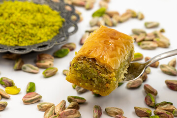 Baklava with pistachio on a white background. Traditional Turkish cuisine delicacies. Local name fıstıkli baklava