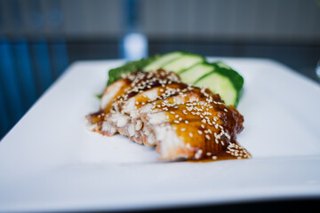 eel pieces in unagi sauce with cucumber japanese cuisine delivery